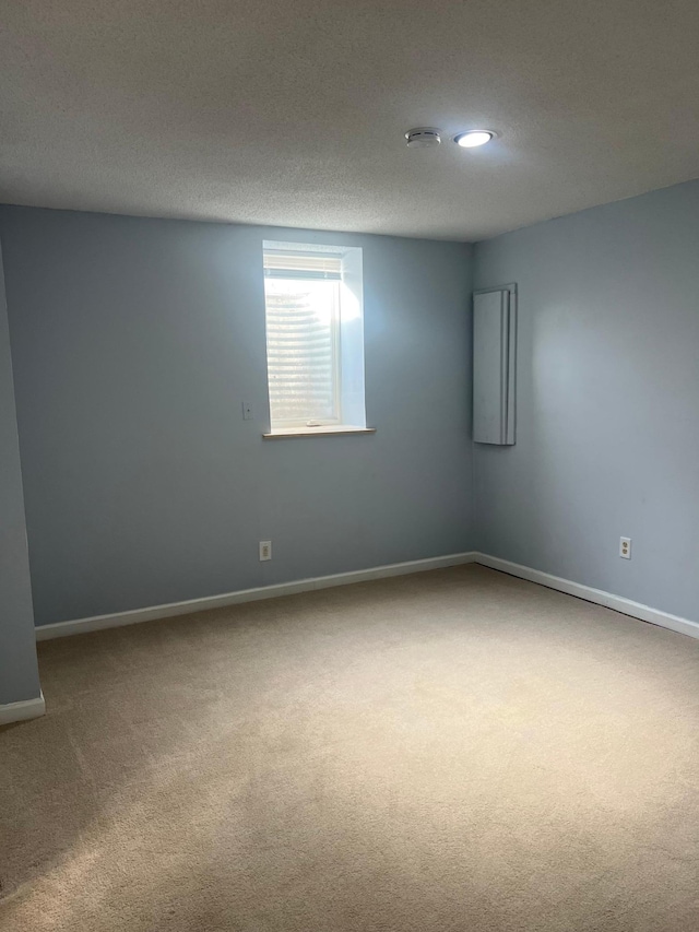 empty room featuring carpet and a textured ceiling