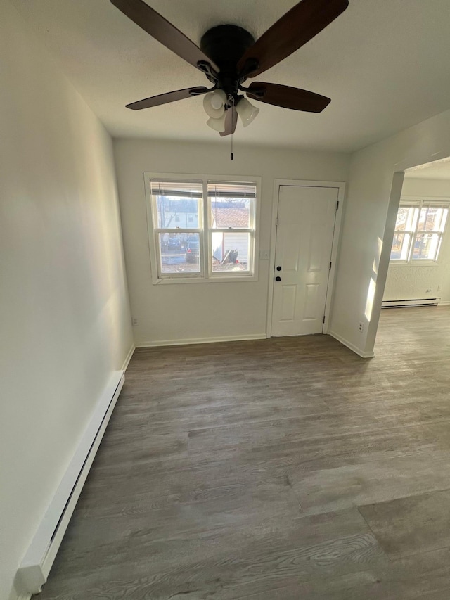 entryway with hardwood / wood-style flooring, ceiling fan, and a baseboard radiator