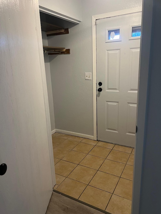 entryway with light tile patterned flooring