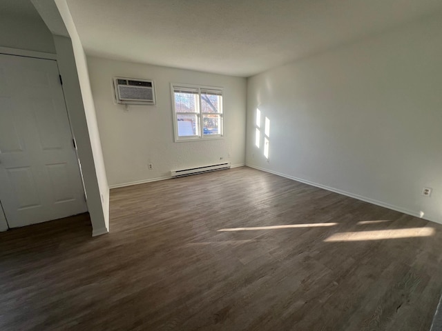 interior space with dark hardwood / wood-style flooring, a baseboard radiator, and a wall mounted AC