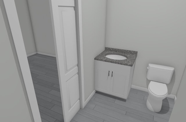 bathroom featuring hardwood / wood-style flooring, vanity, and toilet