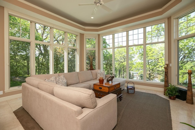 sunroom with ceiling fan and a raised ceiling