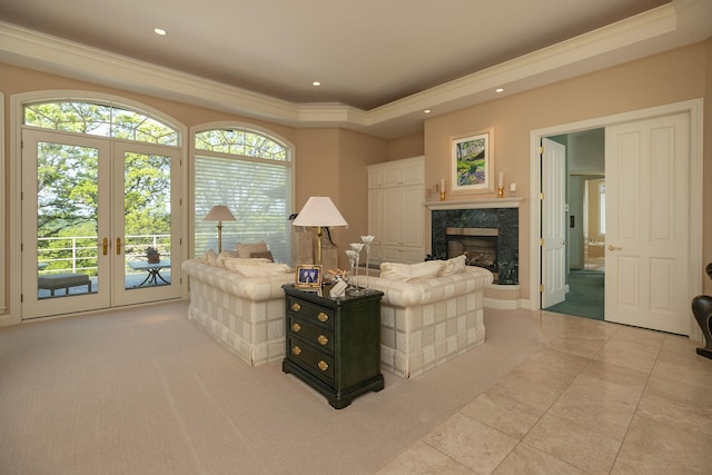 sitting room featuring a fireplace, french doors, light tile patterned floors, and ornamental molding