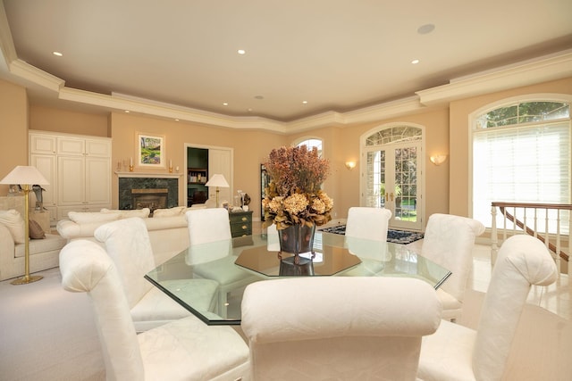 dining area with crown molding and a premium fireplace