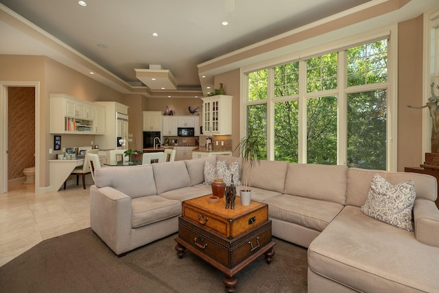 tiled living room with a healthy amount of sunlight and ornamental molding