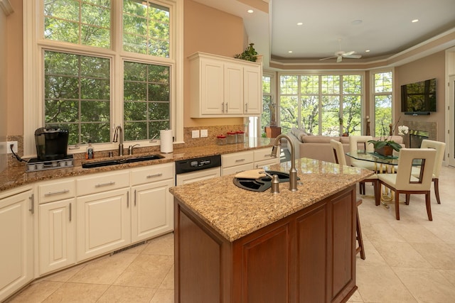 kitchen with white cabinetry, a wealth of natural light, and sink