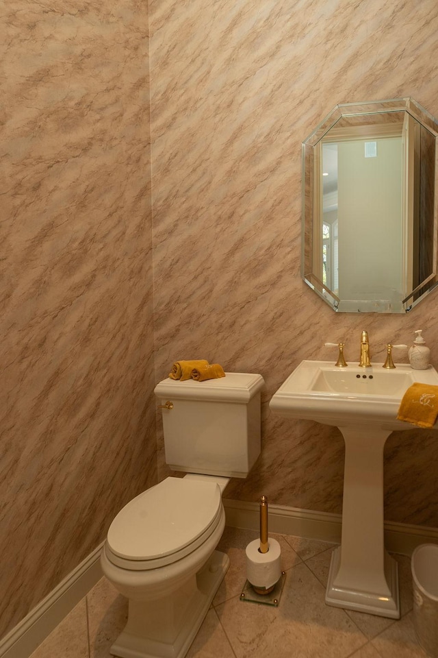 bathroom featuring tile patterned flooring, toilet, and sink