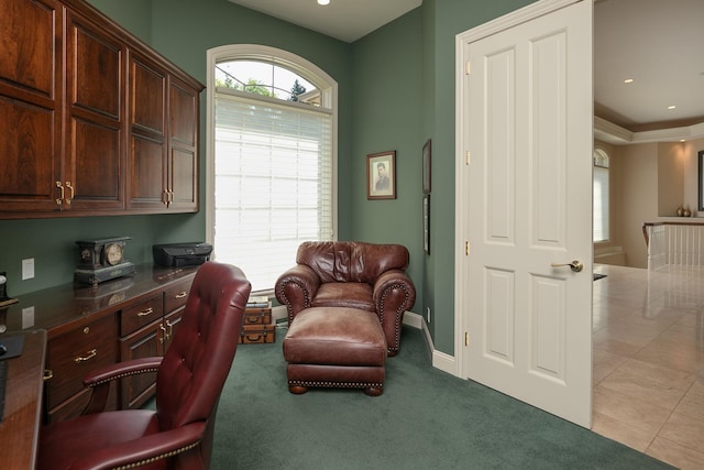 office with built in desk and light tile patterned flooring