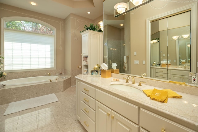 bathroom with tile patterned flooring, vanity, and shower with separate bathtub