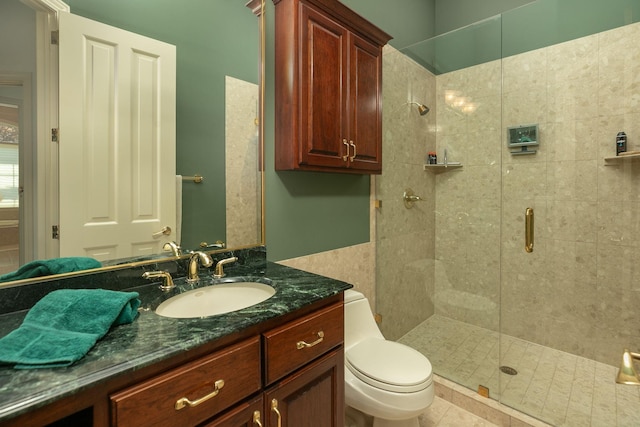 bathroom featuring tile patterned floors, vanity, toilet, and an enclosed shower