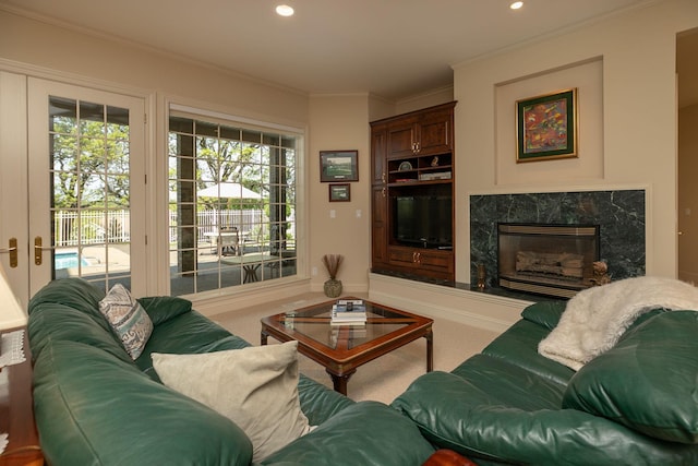 carpeted living room with crown molding and a high end fireplace