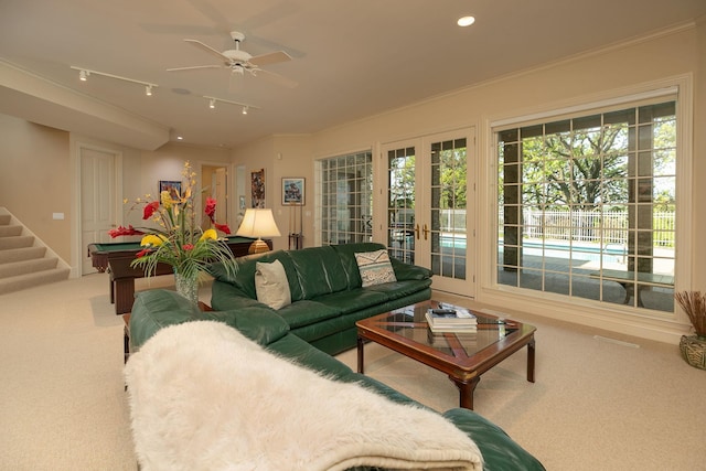 living room featuring carpet, ceiling fan, ornamental molding, and french doors