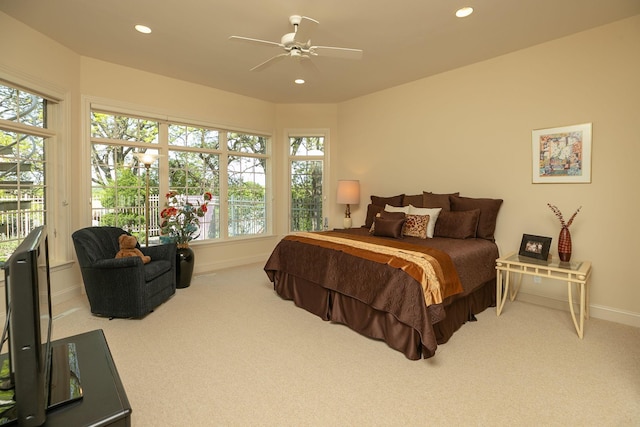 bedroom with carpet flooring, access to exterior, multiple windows, and ceiling fan