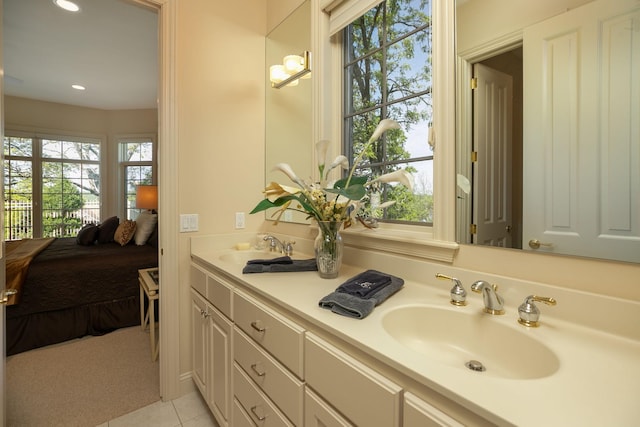 bathroom featuring tile patterned flooring, vanity, and a wealth of natural light