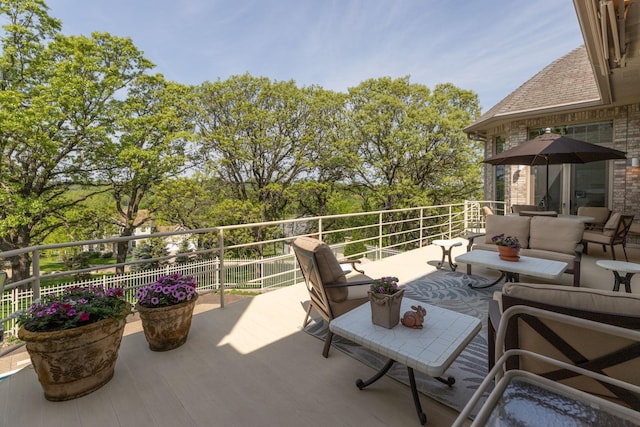 view of patio with outdoor lounge area and a balcony