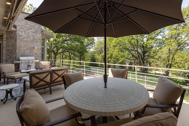 view of patio / terrace with an outdoor living space, a balcony, and a grill