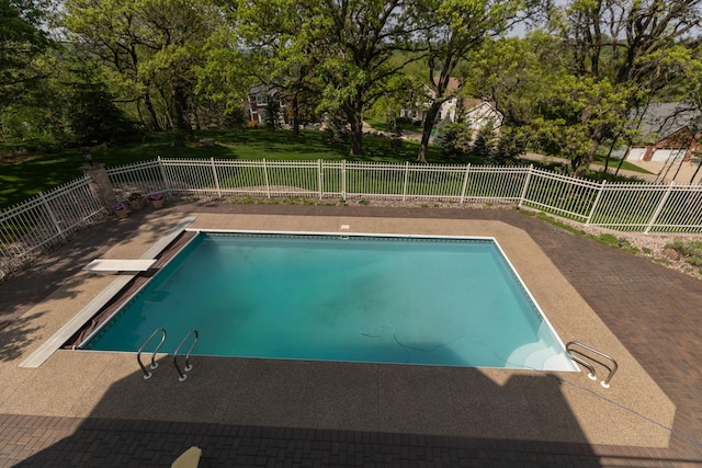 view of pool featuring a patio area and a diving board