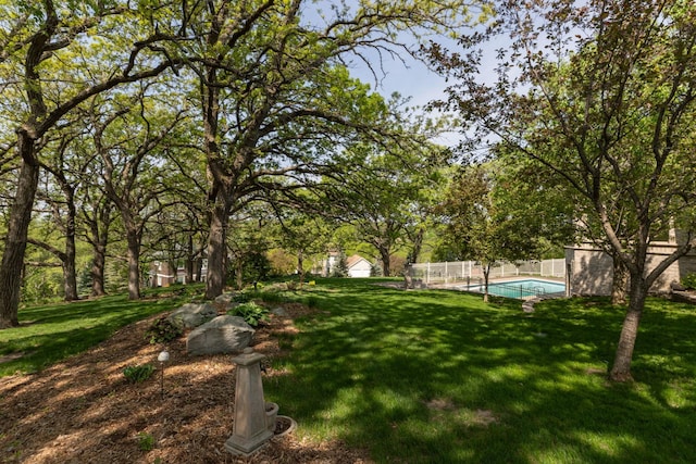 view of yard featuring a fenced in pool