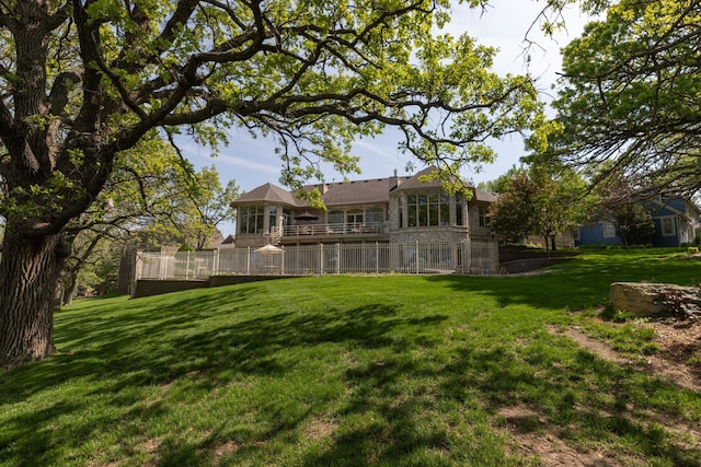 rear view of house featuring a lawn