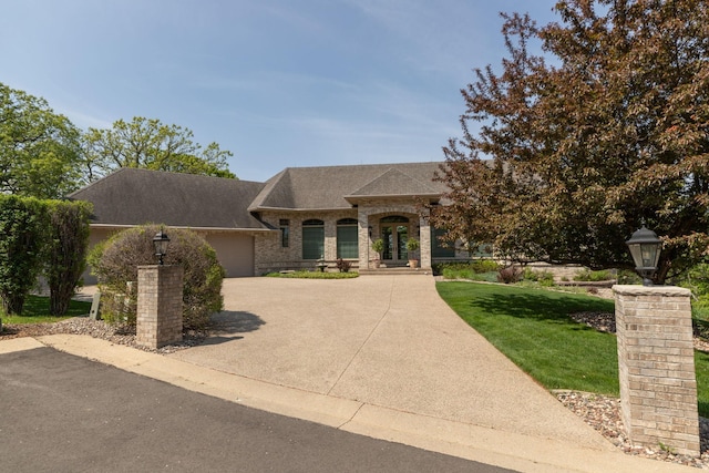 view of front of house featuring a garage and a front lawn