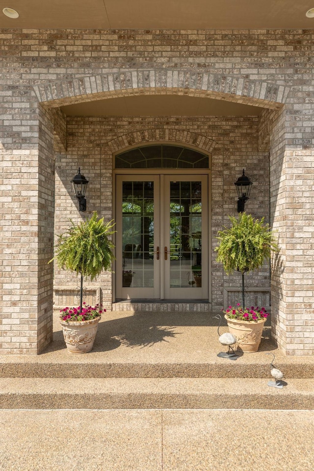 view of exterior entry featuring french doors