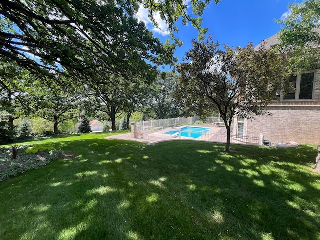 view of yard with a fenced in pool and a patio area