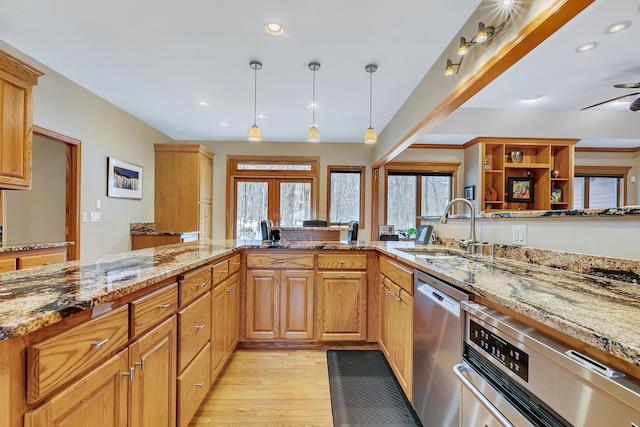 kitchen with light hardwood / wood-style flooring, dishwasher, sink, light stone countertops, and ceiling fan