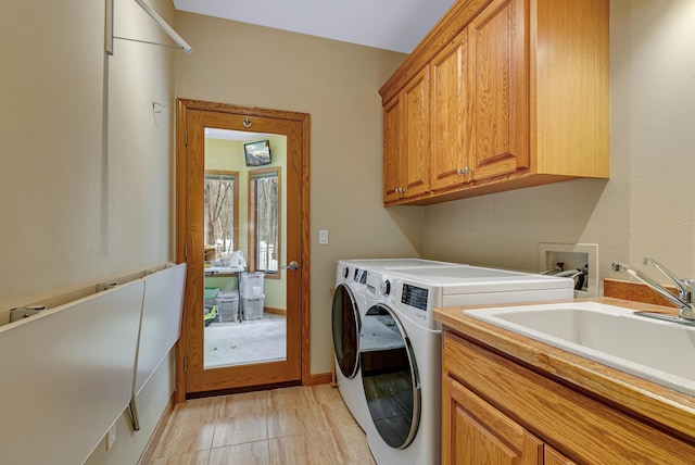 washroom featuring independent washer and dryer, cabinets, sink, and light tile patterned flooring