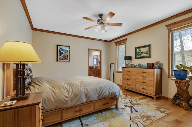 bedroom featuring crown molding, light hardwood / wood-style flooring, ceiling fan, and ensuite bathroom