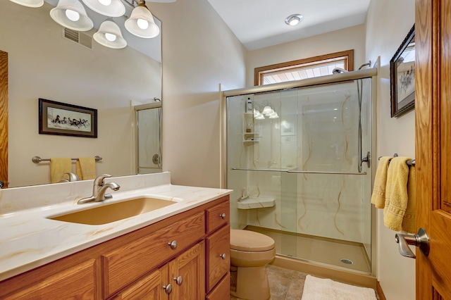 bathroom with an enclosed shower, tile patterned flooring, toilet, and vanity