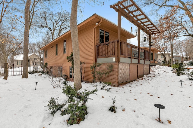 snow covered property with a deck