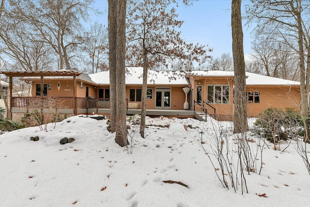 view of snow covered rear of property