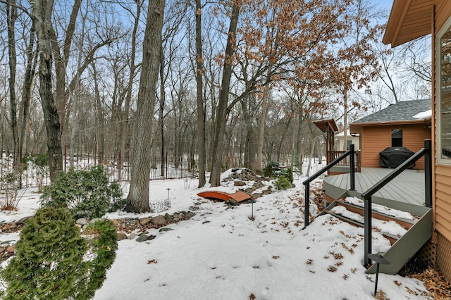 yard covered in snow featuring a wooden deck