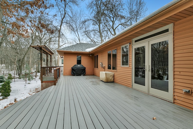 snow covered deck featuring a grill