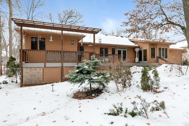 snow covered property featuring a pergola