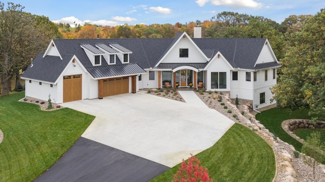 935 Lakewood Hills Rd, Eagan, MN 55123 - modern farmhouse featuring driveway, a chimney, a front yard, and covered porch
