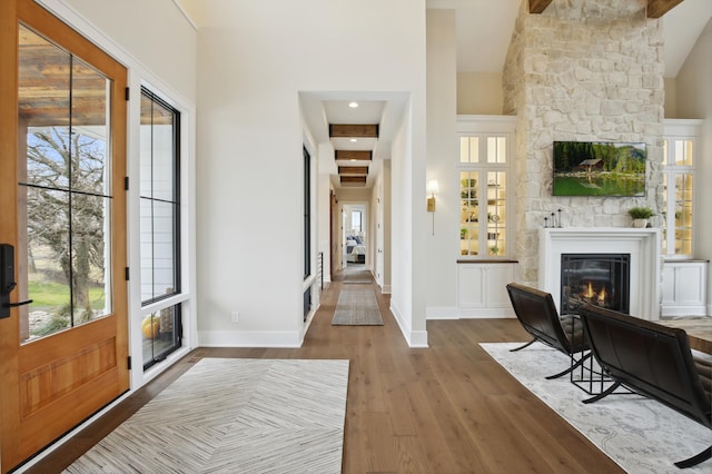 935 Lakewood Hills Rd, Eagan, MN 55123 - foyer entrance with a large fireplace, wood finished floors, plenty of natural light, baseboards, and high vaulted ceiling