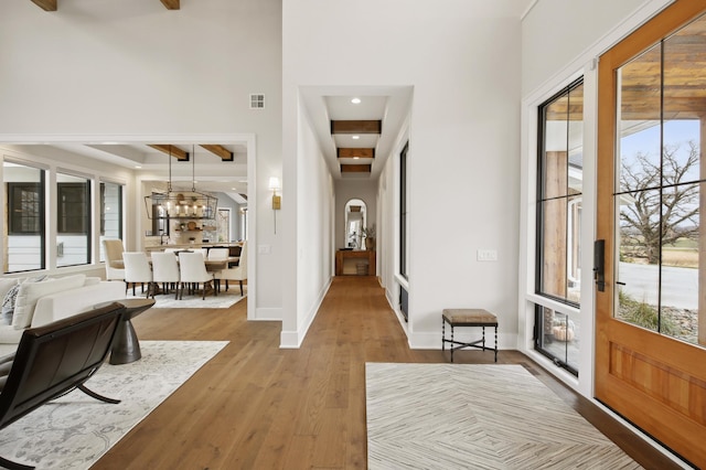 935 Lakewood Hills Rd, Eagan, MN 55123 - entrance foyer featuring wood finished floors, arched walkways, a high ceiling, baseboards, and beamed ceiling