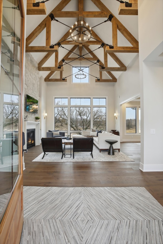 935 Lakewood Hills Rd, Eagan, MN 55123 - living area with high vaulted ceiling, a chandelier, a fireplace, wood finished floors, and beamed ceiling