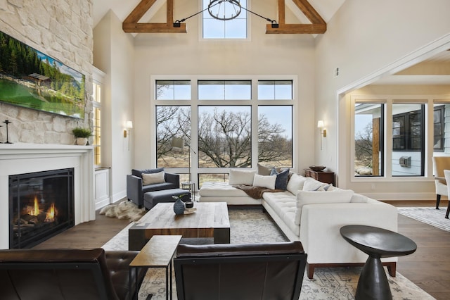 935 Lakewood Hills Rd, Eagan, MN 55123 - living room featuring high vaulted ceiling, a fireplace, wood finished floors, and baseboards