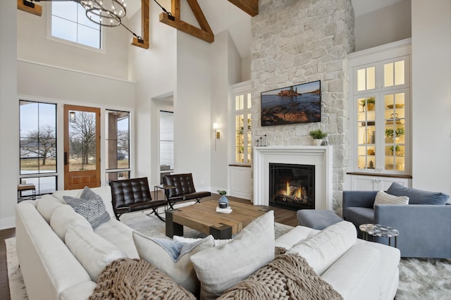 935 Lakewood Hills Rd, Eagan, MN 55123 - living area with a stone fireplace, wood finished floors, high vaulted ceiling, beamed ceiling, and baseboards