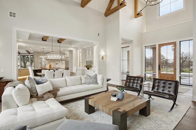 935 Lakewood Hills Rd, Eagan, MN 55123 - living room featuring a chandelier, a high ceiling, wood finished floors, beamed ceiling, and baseboards
