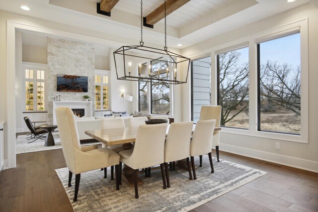 935 Lakewood Hills Rd, Eagan, MN 55123 - dining space featuring a chandelier, dark wood-style flooring, a fireplace, baseboards, and beam ceiling