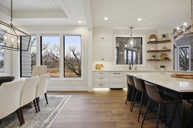935 Lakewood Hills Rd, Eagan, MN 55123 - dining space with a chandelier, recessed lighting, wood finished floors, and baseboards