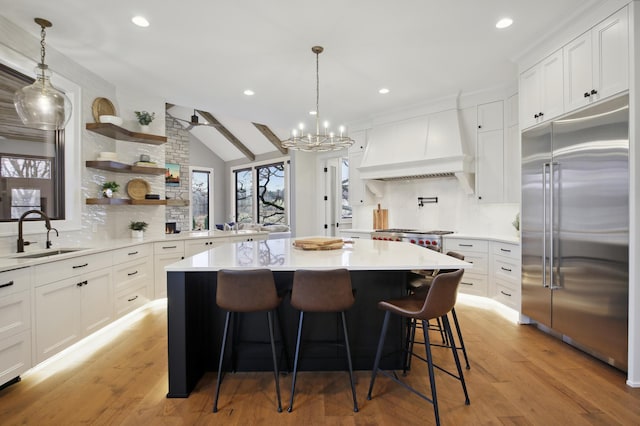 935 Lakewood Hills Rd, Eagan, MN 55123 - kitchen featuring built in fridge, a sink, custom range hood, tasteful backsplash, and recessed lighting