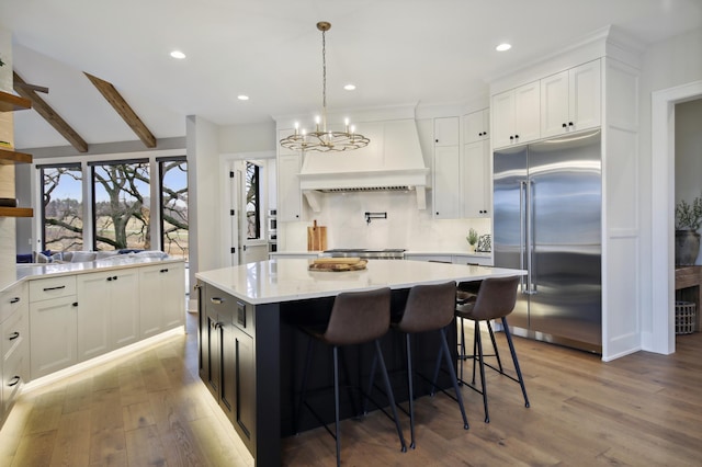 935 Lakewood Hills Rd, Eagan, MN 55123 - kitchen featuring built in fridge, custom range hood, wood finished floors, light countertops, and recessed lighting