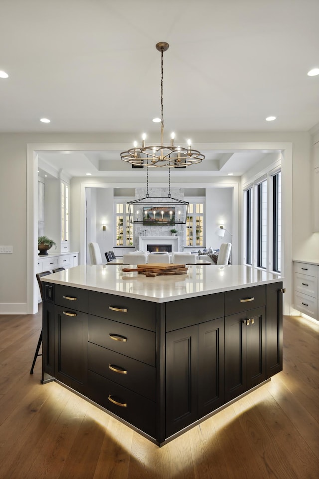 935 Lakewood Hills Rd, Eagan, MN 55123 - kitchen featuring a chandelier, wood finished floors, dark cabinetry, a large island, and recessed lighting