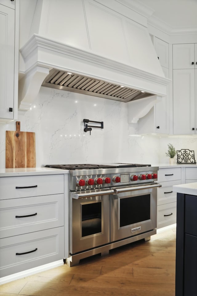 935 Lakewood Hills Rd, Eagan, MN 55123 - kitchen featuring double oven range, premium range hood, decorative backsplash, white cabinetry, and light countertops
