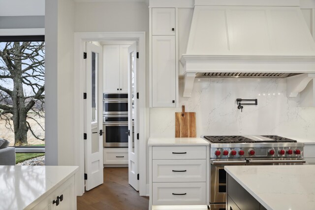 935 Lakewood Hills Rd, Eagan, MN 55123 - kitchen with appliances with stainless steel finishes, custom exhaust hood, tasteful backsplash, and white cabinetry