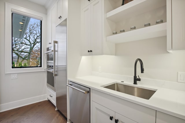 935 Lakewood Hills Rd, Eagan, MN 55123 - kitchen with dishwasher, a sink, white cabinetry, and light countertops